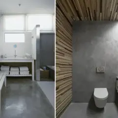 Baño con suelo de hormigón pulido, paredes de microcemento y detalles en madera.