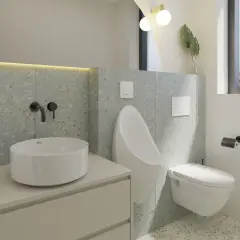 Modernos baños alicatados a media altura con lavabo sobre encimera, urinario y cisterna empotrada.