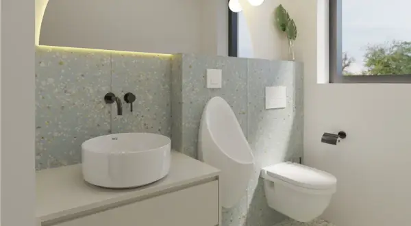 Modernos baños alicatados a media altura con lavabo sobre encimera, urinario y cisterna empotrada.