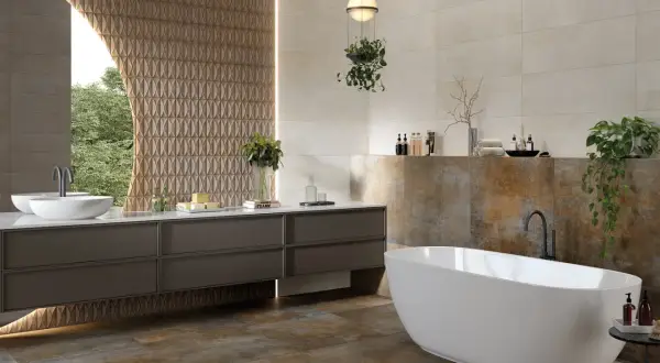 Baño moderno con bañera exenta y lavabo doble. La diferencia entre baldosa y azulejo se aprecia en las paredes, unas lisas y otras con relieve.