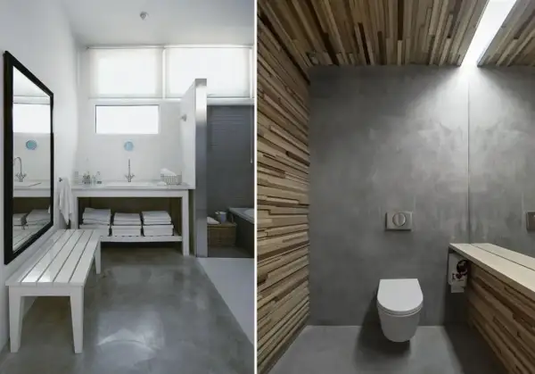 Baño con suelo de hormigón pulido, paredes de microcemento y detalles en madera.