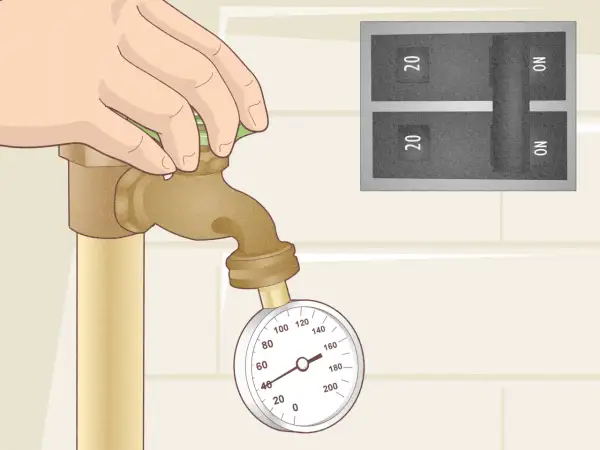 Mano girando la llave de paso con un manómetro y un interruptor de circuito regular presostato.