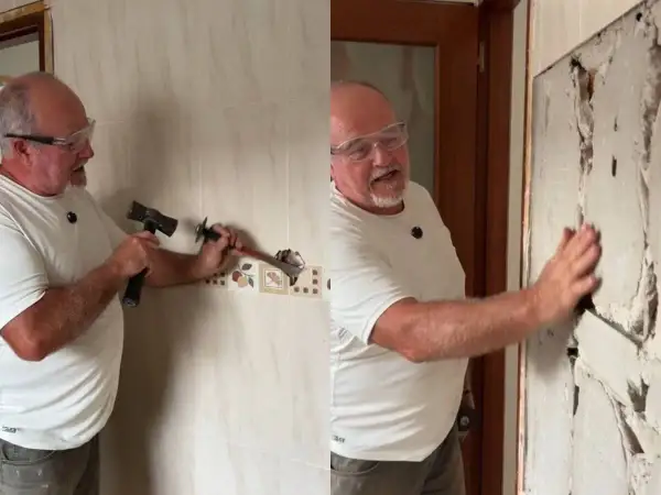 Hombre con gafas de seguridad usando un martillo y cincel para quitar azulejos de una pared.